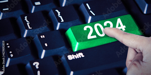 Closeup of a finger pressing the 2024 button on laptop computer