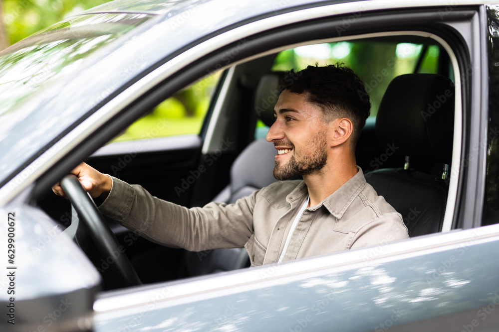 Young Man driving his car on way to work.