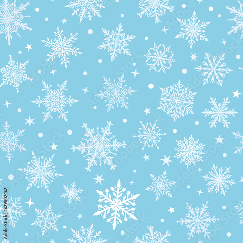 Christmas seamless pattern of beautiful complex snowflakes in light blue and white colors. Winter background with falling snow
