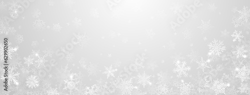 Christmas background of beautiful complex big and small snowflakes in gray colors. Winter illustration with falling snow