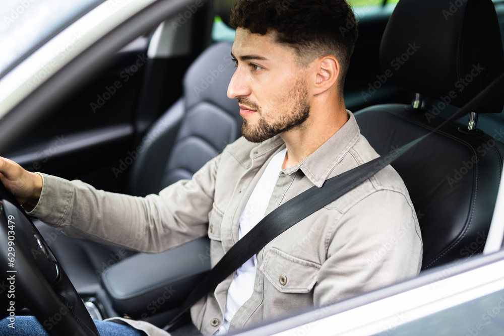 Young hispanic man driving car at street wear safe belt Young hispanic man driving car at street wear safe belt