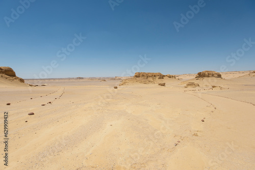 Barren desert landscape in hot climate with mountain rock formation