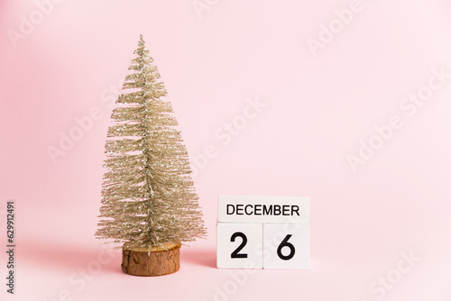 Christmas decoration and calendar with date December 26 on pink paper background with copy space, Boxing Day. Christmas and New Year celebration concept.