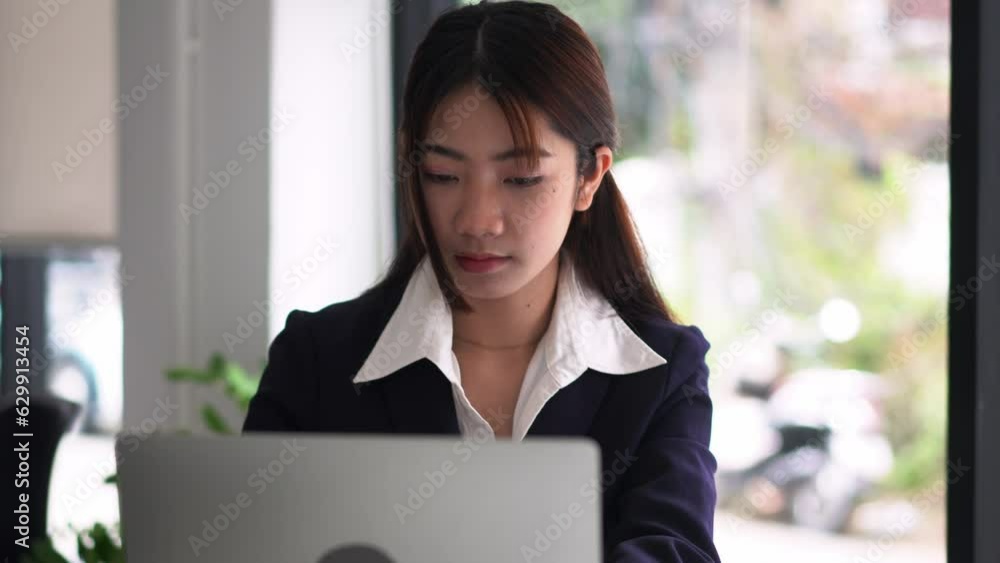 A professional beautiful business asian woman working on a laptop computer working in office, Attractive female employee. A professional beautiful business asian woman working on a laptop computer working in office, Attractive female employee.
