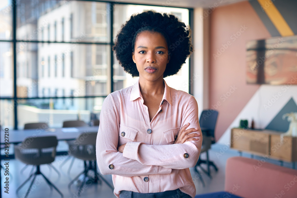Portrait Of Businesswoman With Serious Expression Standing In Empty Office Portrait Of Businesswoman With Serious Expression Standing In Empty Office