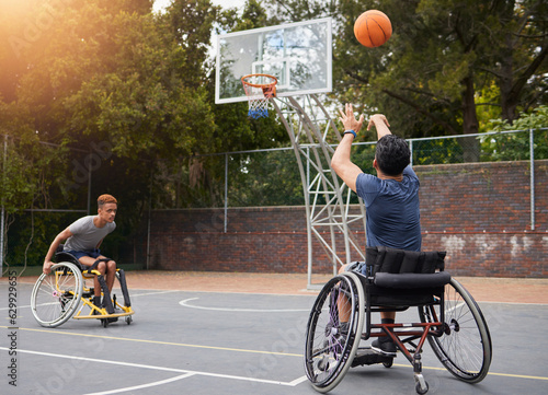 Sports, basketball and men in wheelchair for goal in training, exercise and workout on outdoor court. Fitness, team and male people with a disability shoot ball for competition, practice and games