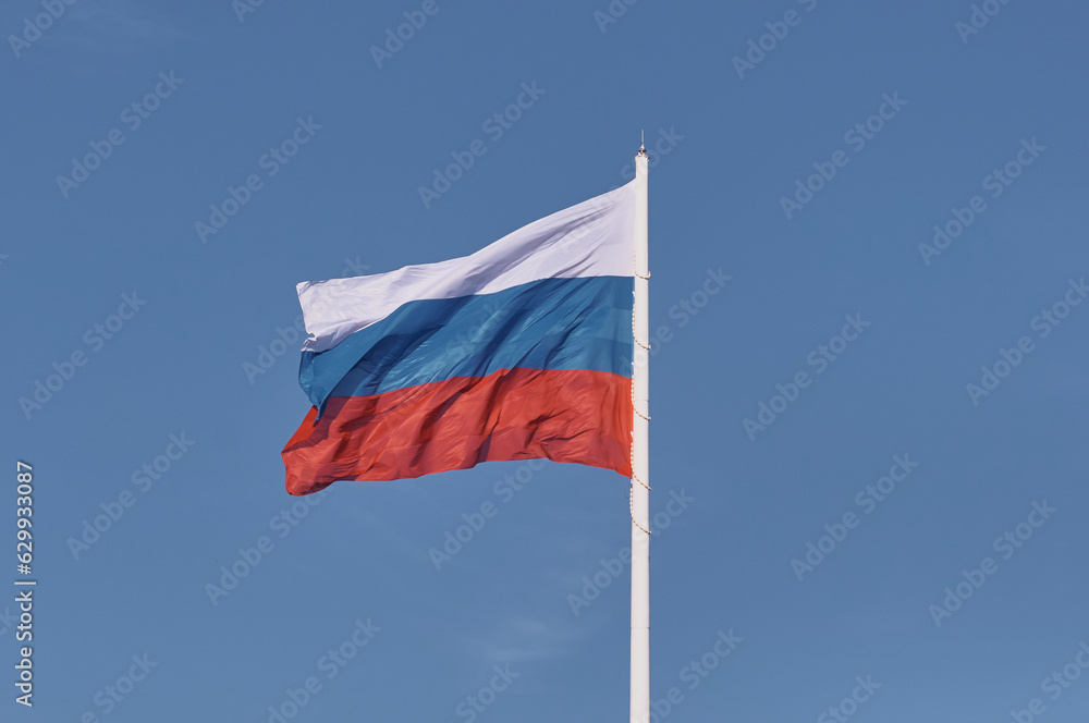 Large flag of the Russian Federation on a flagpole 75 meters high. Technological device with wind speed sensors and automatic flag height adjustment system. Blagoveshchensk, Far East, Russia Large flag of the Russian Federation on a flagpole 75 meters high. Technological device with wind speed sensors and automatic flag height adjustment system. Blagoveshchensk, Far East, Russia