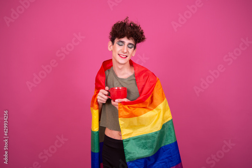 lgbt culture. Funny guy doing makeup. Pink background.