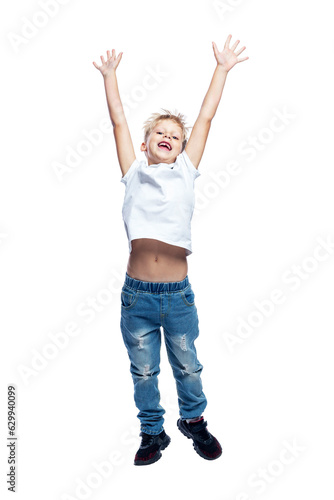 Joyful boy is jumping. A child in jeans and a white T-shirt. Positive, active and energetic. Isolated on white background. Vertical. Full height.