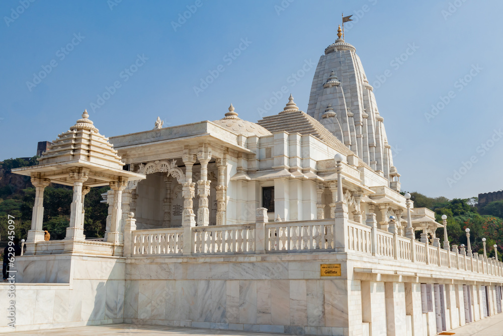 Low angle wide view of Birla temple made with marble and. blue sky in the background for Hinduism and worship concept.