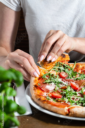Obraz na płótnie Photo of italian parma pizza and woman's hand