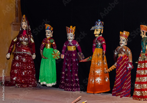Night time photography of a Puppet show with different characters dressed up in traditional dresses.
