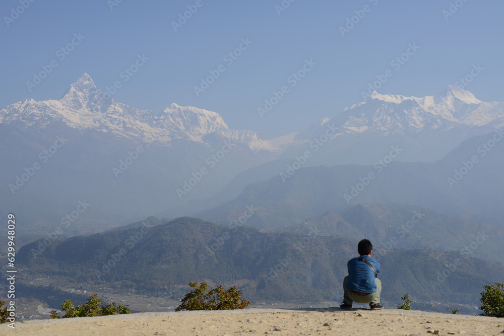The Himalayan mountains and a sitting man