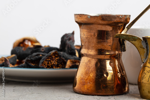 фотографія Copper turk with coffee and dried fruit pieces on table
