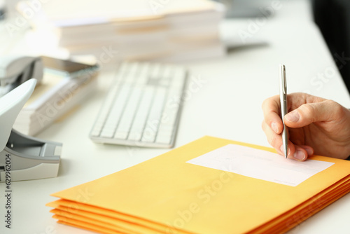 Cuadro en lienzo Person fill in address on yellow envelope of postal correspondence for application hiring concept