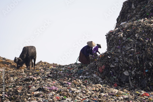 Huge mountains of garbage piled up in the Piyungan landfill, scavengers and animals can be seen. Waste management emergency in Yogyakarta. photo