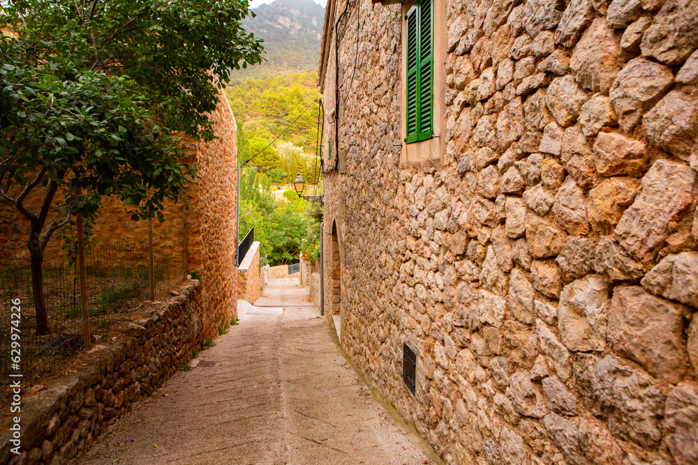 View of a medieval street of the picturesque Spanish-style village Valdemossa in Majorca or Mallorca island, Spain.