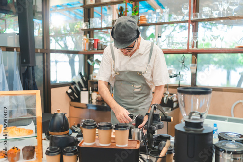 Barista at a coffee shop pr...
