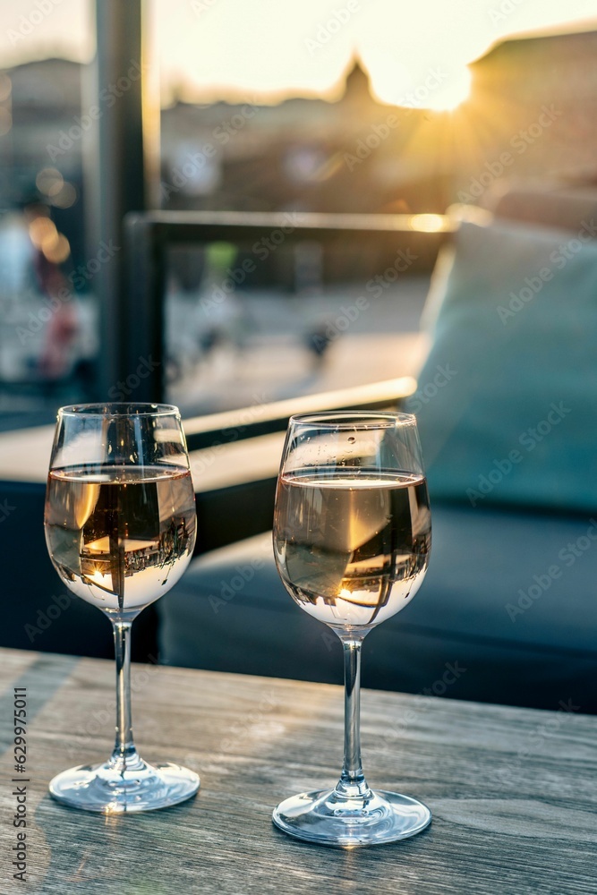 Two crystal clear glasses of bubbly champagne on a wooden table Two crystal clear glasses of bubbly champagne on a wooden table