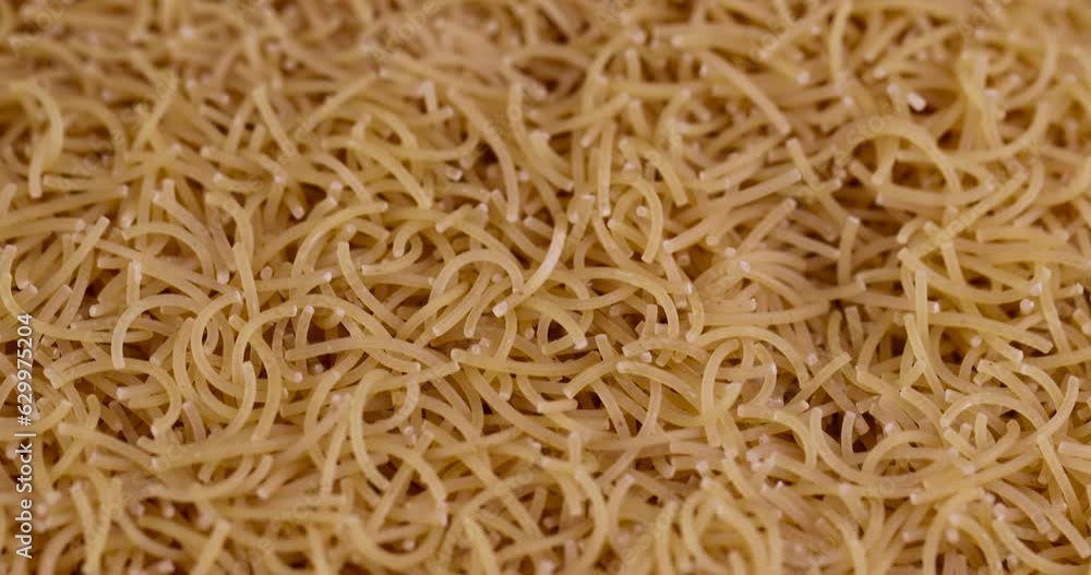 thin pasta made of high-quality wheat flour, uncooked pasta made of flour and water close-up thin pasta made of high-quality wheat flour, uncooked pasta made of flour and water close-up