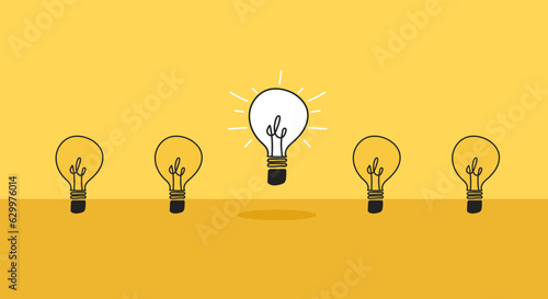 Creative new idea concept with light bulbs. One light bulb standing out from others bulbs floating on yellow background.