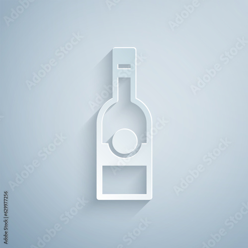 Paper cut Glass bottle of vodka icon isolated on grey background. Paper art style. Vector
