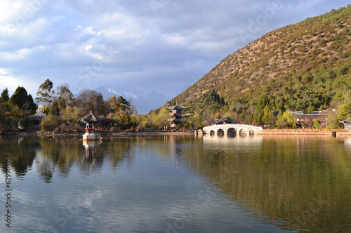 Black Dragon Pool : chinese style bridge on the lake in the park in lijiang old town, the world heritage site of UNESCO