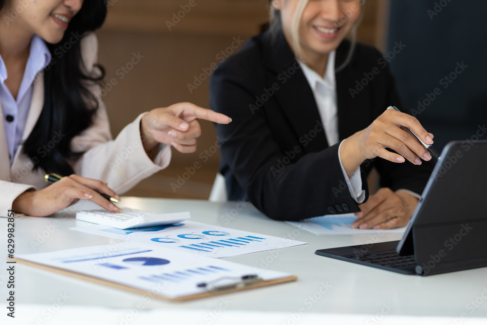 Businesswoman meeting to discuss analysis of growth graphs and financial charts for investment planning. Businesswoman meeting to discuss analysis of growth graphs and financial charts for investment planning.