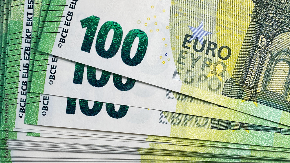 100 euro bills. Top view of a stack of hundred Euro notes. Close-up. The single currency of the European Union. Cash banknotes. European currency. Background of money. 100 euro bills. Top view of a stack of hundred Euro notes. Close-up. The single currency of the European Union. Cash banknotes. European currency. Background of money.