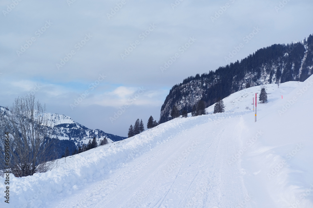 beautiful white landscape, high mountains Swiss Alps, wide alpine winter road cleared, large snowdrifts on the side, Healthy Lifestyle Concept, Winter Activity, travel by car