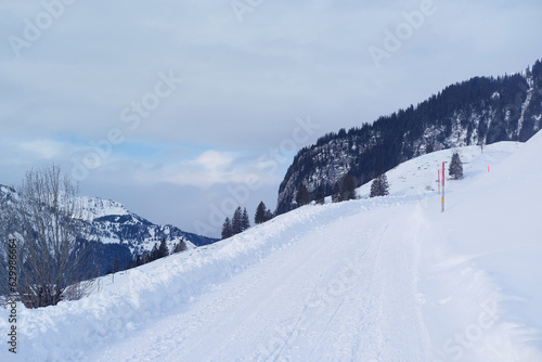 beautiful white landscape, high mountains Swiss Alps, wide alpine winter road cleared, large snowdrifts on the side, Healthy Lifestyle Concept, Winter Activity, travel by car © kittyfly