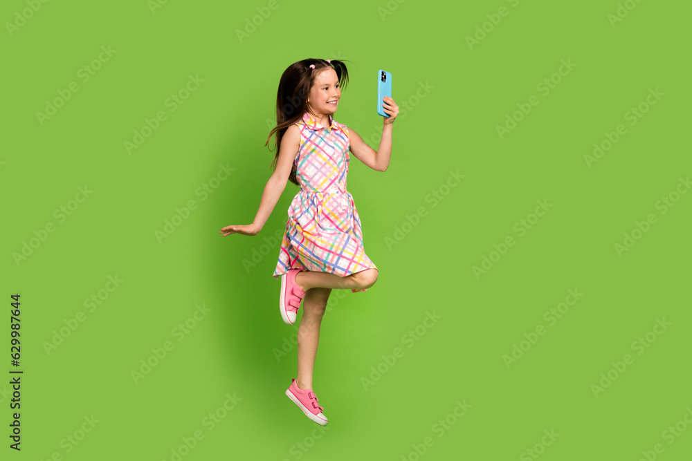 Full length photo of charming preteen age little girl blogger fling air ...