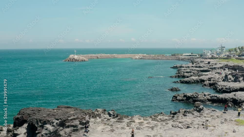 Drone landscape of magnificent volcanic rocks and blue sea. jeju island. Drone landscape of magnificent volcanic rocks and blue sea. jeju island.