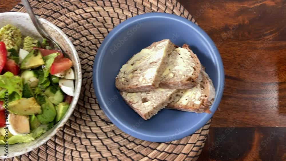 Mixed Salad Bowl and Bread on Butter on Wooden Table Top Mixed Salad Bowl and Bread on Butter on Wooden Table Top
