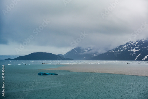 Cruise to Hubbard Glacier Bay in Alaska with floating ice bergs and drift ice floes on ocean water surface surrounded by snow cap mountains and wildlife wild nature scenery Last Frontier adventure photo