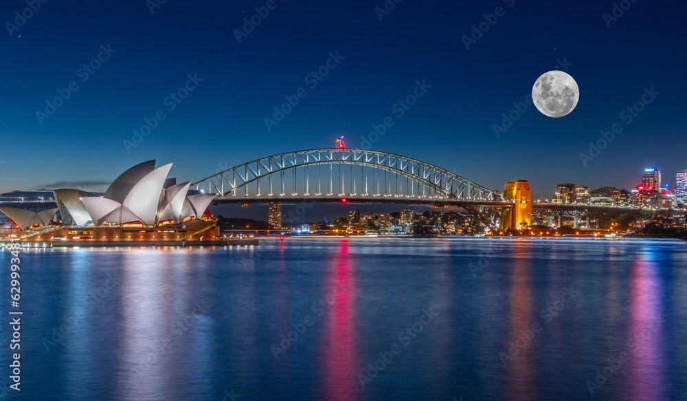 Panoramic night view of Sydney Harbour and CBD buildings on the foreshore in NSW Australia