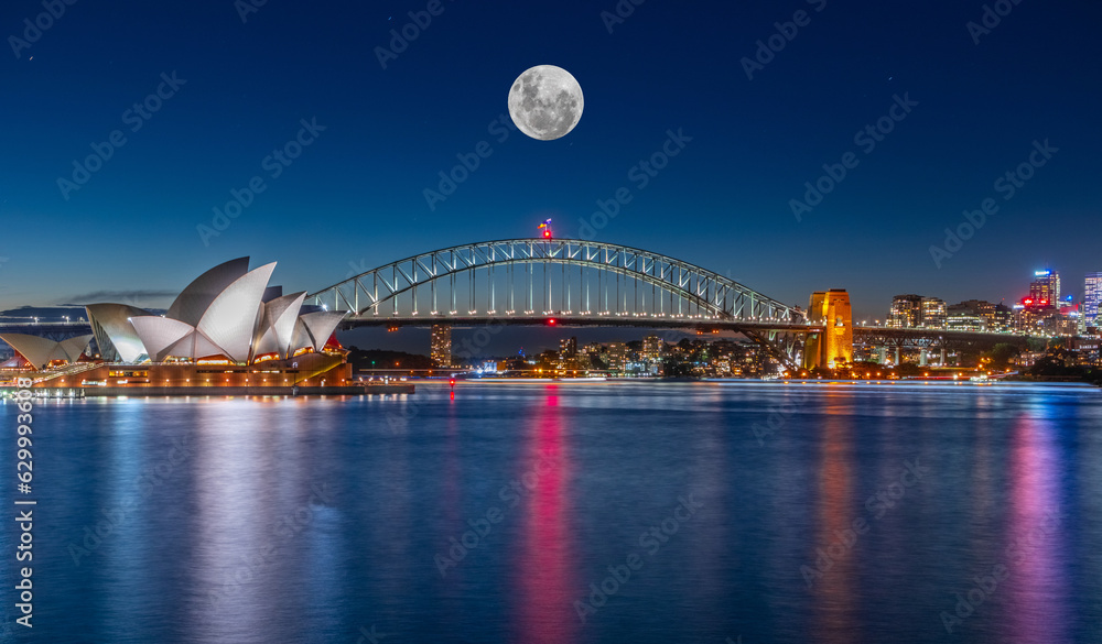 Naklejka premium Panoramic night view of Sydney Harbour and CBD buildings on the foreshore in NSW Australia