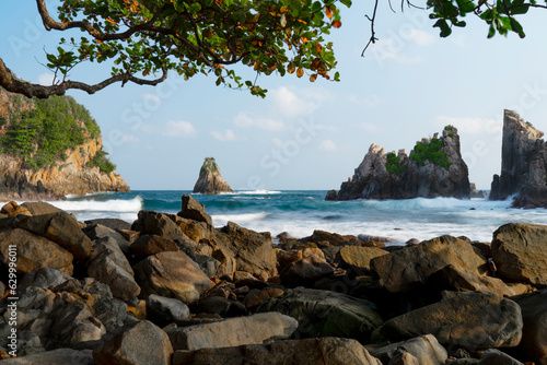 photo of pantai batu layar or pantai gigi hiu at kelumbayan tanggamus lampung, high quality images good for background. long exposure shoot on exotic beach. summer natural rocks corals daylight photo