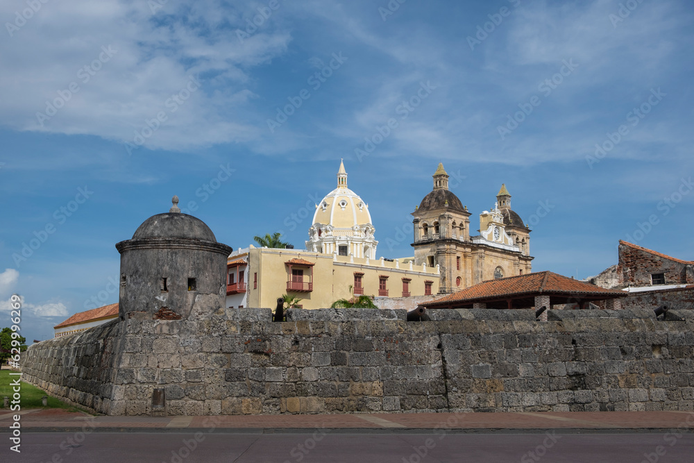 Domes and facades of old churches and cathedrals behind the high wall with cannons in the Old Walled City in Cartagena Colombia.