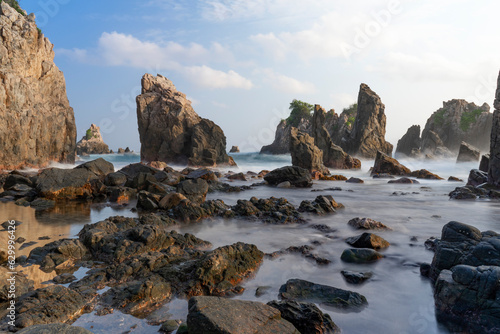 photo of pantai batu layar or pantai gigi hiu at kelumbayan tanggamus lampung, high quality images good for background. long exposure shoot on exotic beach. summer natural rocks corals daylight photo