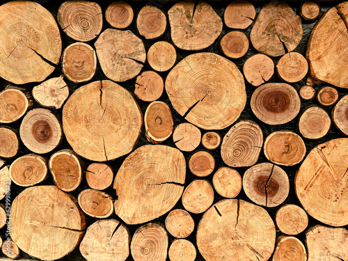 wall of stacked wooden logs. Background texture