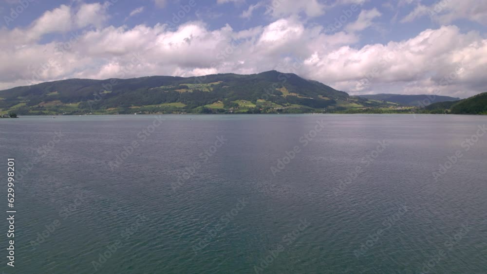 Stunning Austrian mountains from a bird's-eye view. Fascinating blue lake, green mountain forests. Mountain towns. Roads for travel. Stunning Austrian mountains from a bird's-eye view. Fascinating blue lake, green mountain forests. Mountain towns. Roads for travel.
