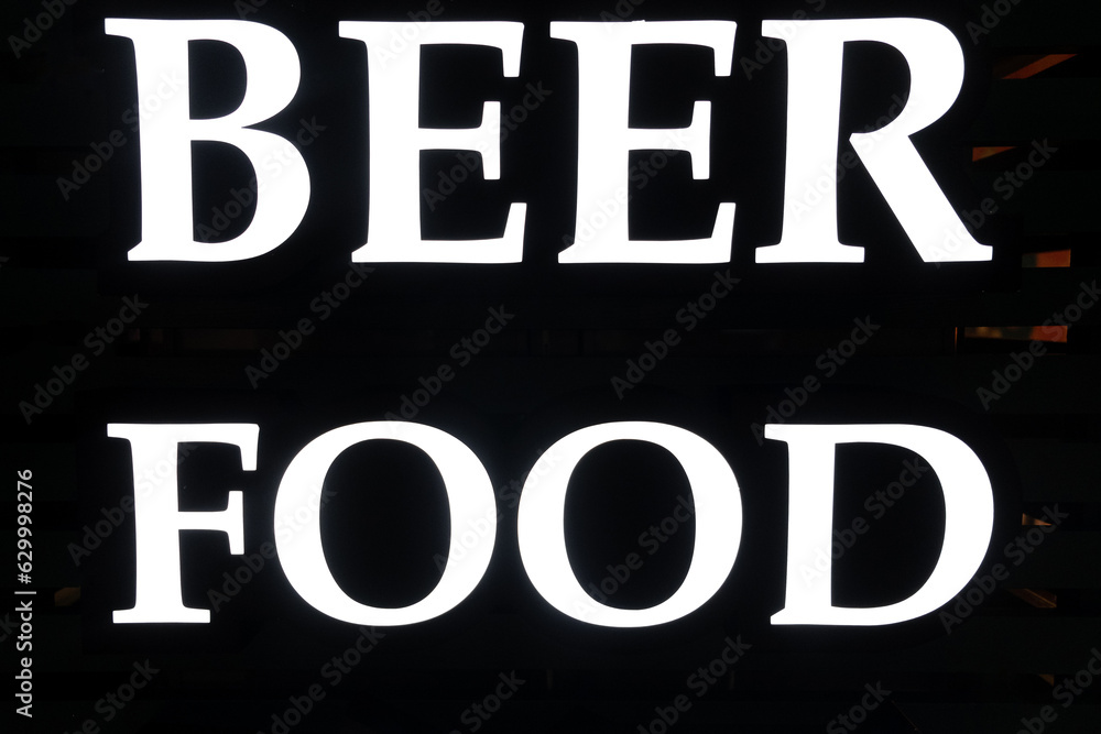 Fototapeta premium The inscription or poster food and beer at the entrance to a bar or cafe. White letters on a black background