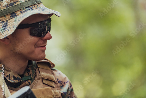 Soldier portrait with protective army tactical gear and weapon having a break and relaxing © .shock