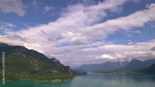 Stunning Austrian mountains from a bird's-eye view. Fascinating blue lake, green mountain forests. Mountain towns. Roads for travel.