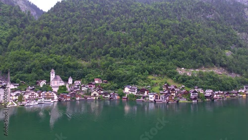 Stunning Austrian mountains from a bird's-eye view. Fascinating blue lake, green mountain forests. Mountain towns. Roads for travel.