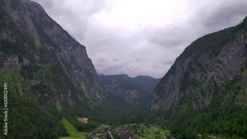 Stunning Austrian mountains from a bird's-eye view. Fascinating blue lake, green mountain forests. Mountain towns. Roads for travel.