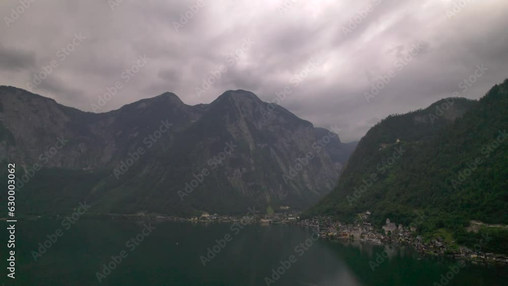 Stunning Austrian mountains from a bird's-eye view. Fascinating blue lake, green mountain forests. Mountain towns. Roads for travel. Stunning Austrian mountains from a bird's-eye view. Fascinating blue lake, green mountain forests. Mountain towns. Roads for travel.