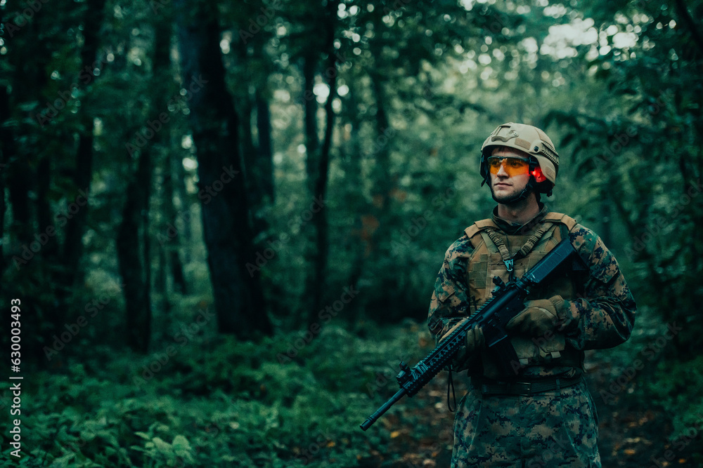 A modern warfare soldier on war duty in dense and dangerous forest areas. Dangerous military rescue operations