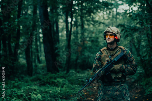 A modern warfare soldier on war duty in dense and dangerous forest areas. Dangerous military rescue operations
